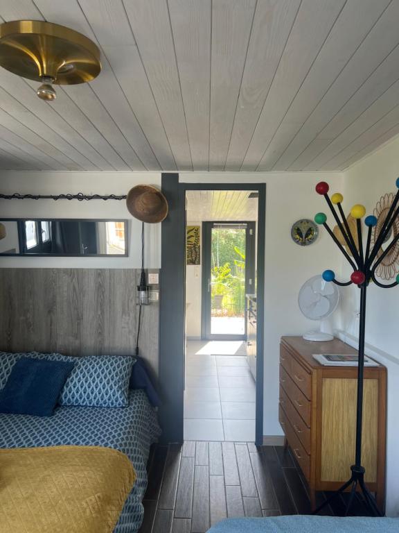 a bedroom with a bed and a wooden ceiling at Gîte PAPYRUS in Sainte-Eulalie-en-Born