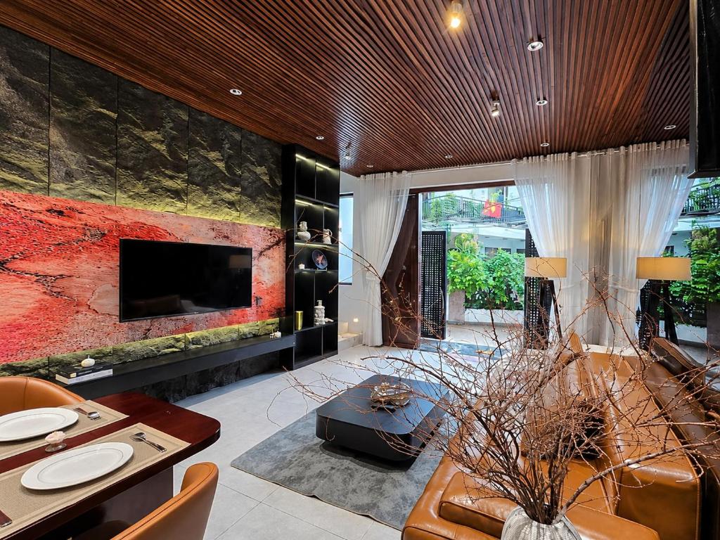 a large living room with a tv and a couch at MONO HAUS Villa Danang in Danang