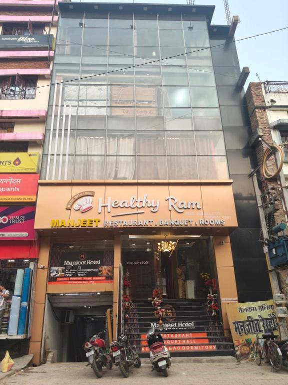 a store with motorcycles parked in front of a building at Manjeet Hotel & Restaurant in Ballia