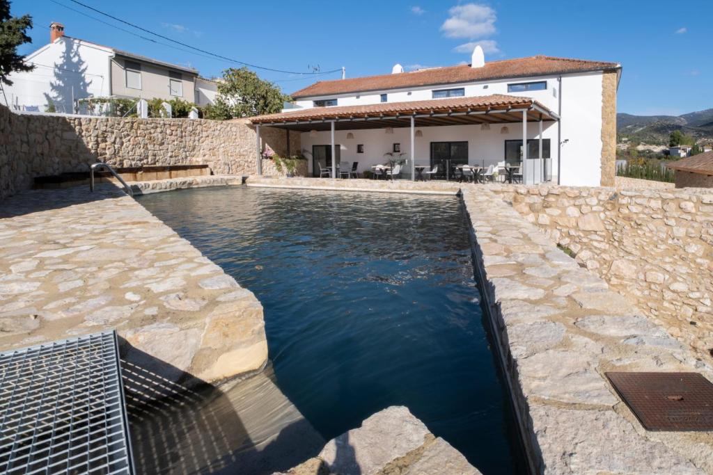 a pool of water in front of a house at EL BATAN Hotel & Spa in Castillo de Locubín