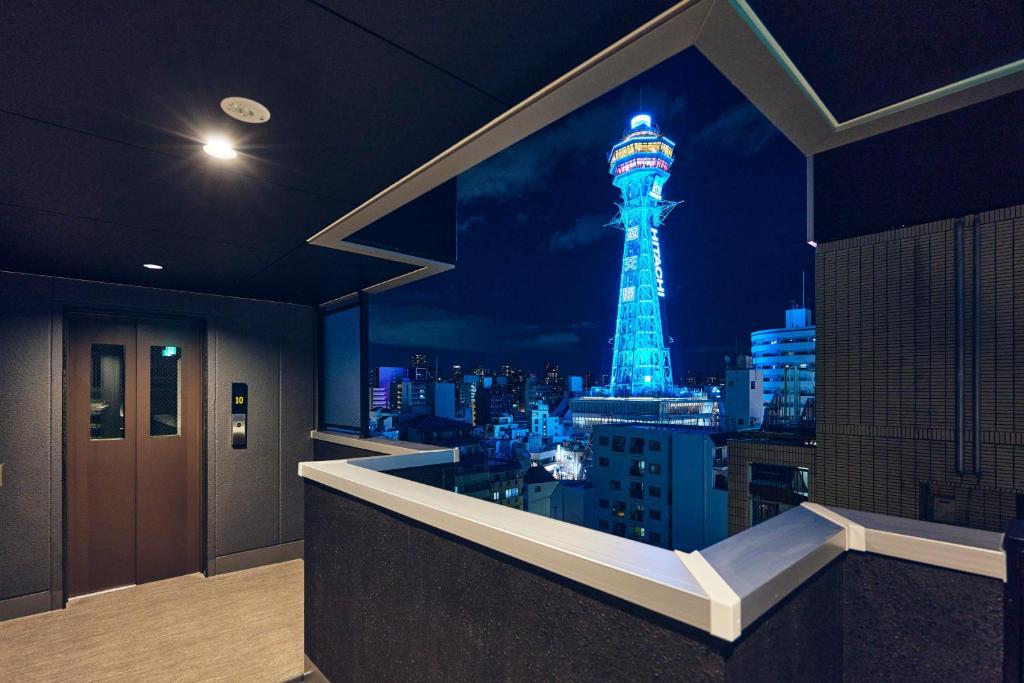 a room with a window with a view of a tower at Montana Wing Yebisu in Osaka