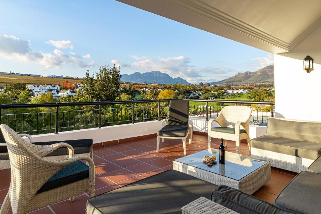 a balcony with a view of the mountains at Winelands Golf Lodges 3 in Stellenbosch