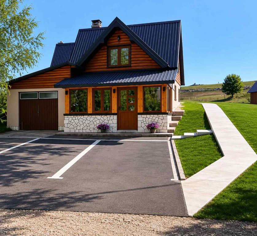 a house with a gambrel roof at Bungalows Ivan in Žabljak