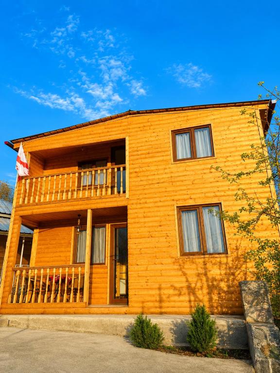 a large wooden house with a balcony on it at Zghapari Wooden Mountain Lodge in Aspindza