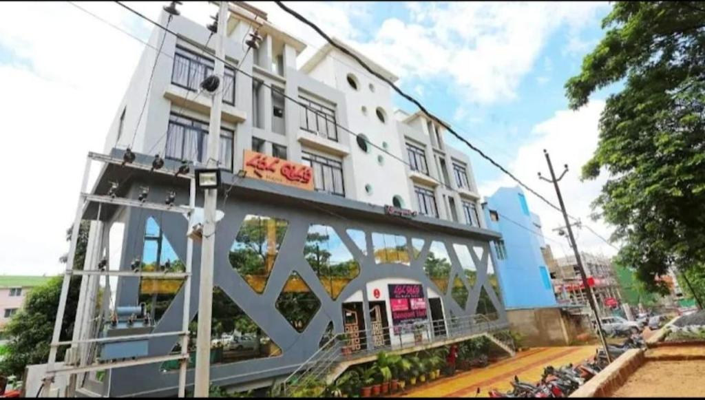 a white building with a bridge in front of it at Hotel Travora Suits -Lalquila in Bhubaneshwar