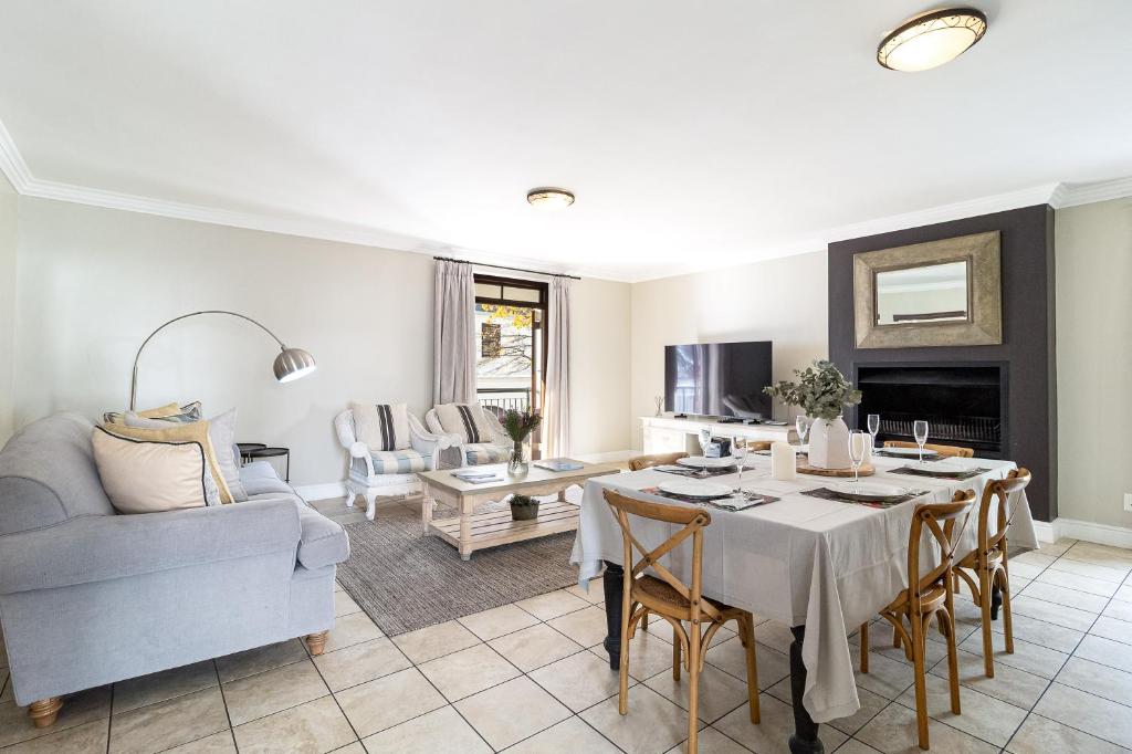 a living room with a table and a couch at Winelands Golf Lodges 10 in Stellenbosch