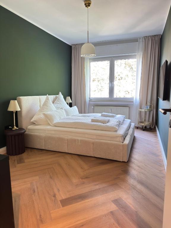 a bedroom with a large bed and a window at Westerntor City Studio in Paderborn