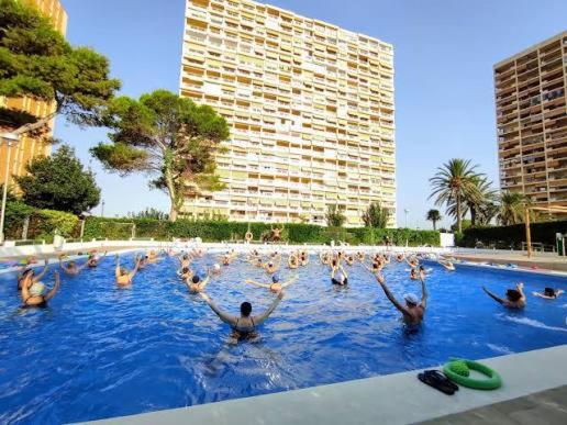 a group of people in a swimming pool at Mediterranean Front Beach Apartment in El Puig