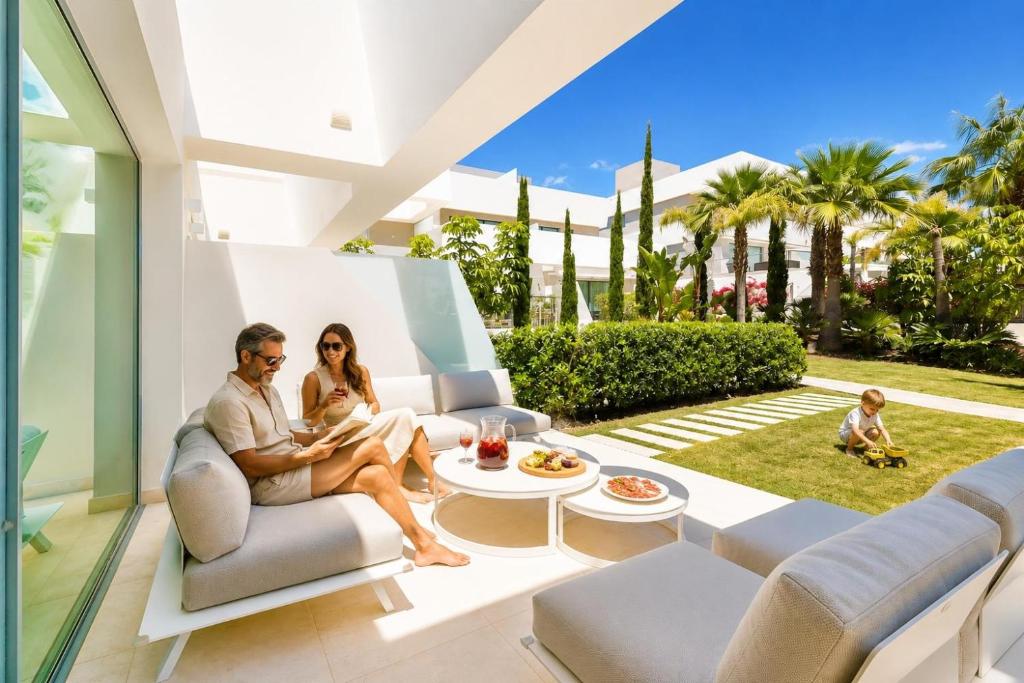 a man and woman sitting on a couch in a living room at La Valvega 47 in Mijas Costa
