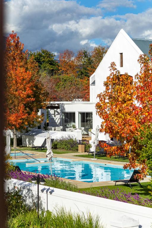 a house with a swimming pool in the yard at Winelands Golf Lodges 14 in Stellenbosch