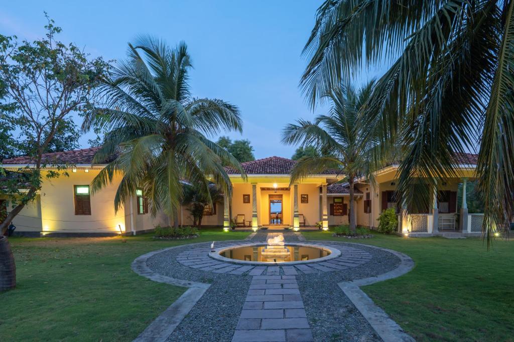 a house with a fountain in the yard at Villa Sethawadi Hotel and Kitesurf Centre in Kalpitiya