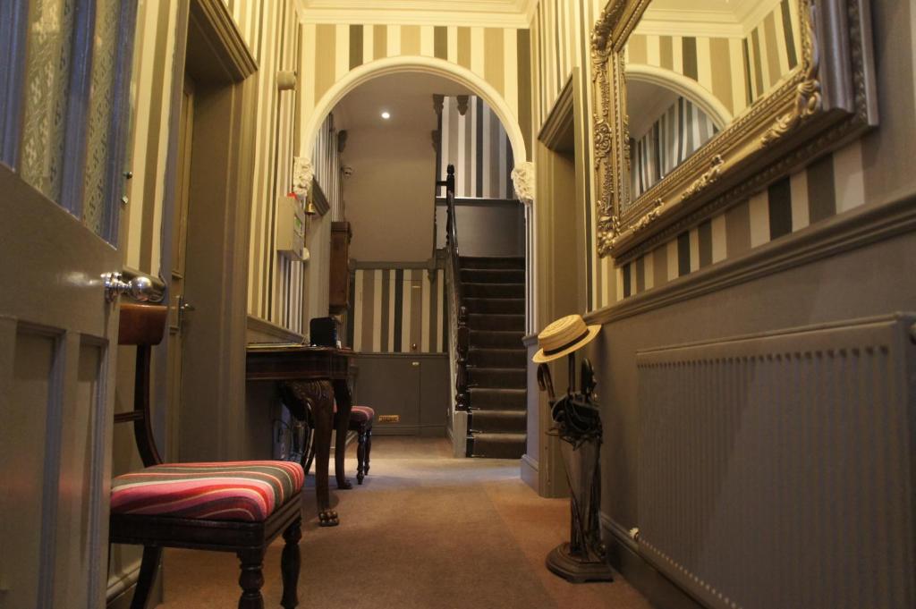 un pasillo con espejo y escaleras en un edificio en Burlington House, en Oxford