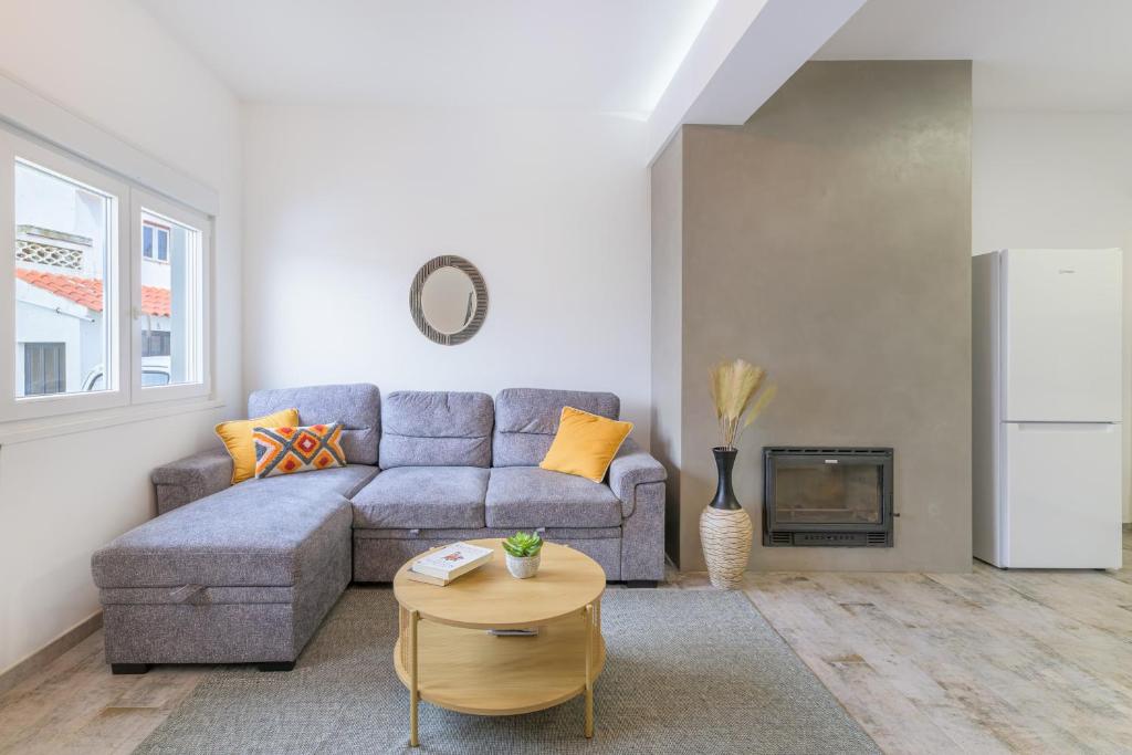 a living room with a couch and a table at Casa Formosa in Odeceixe