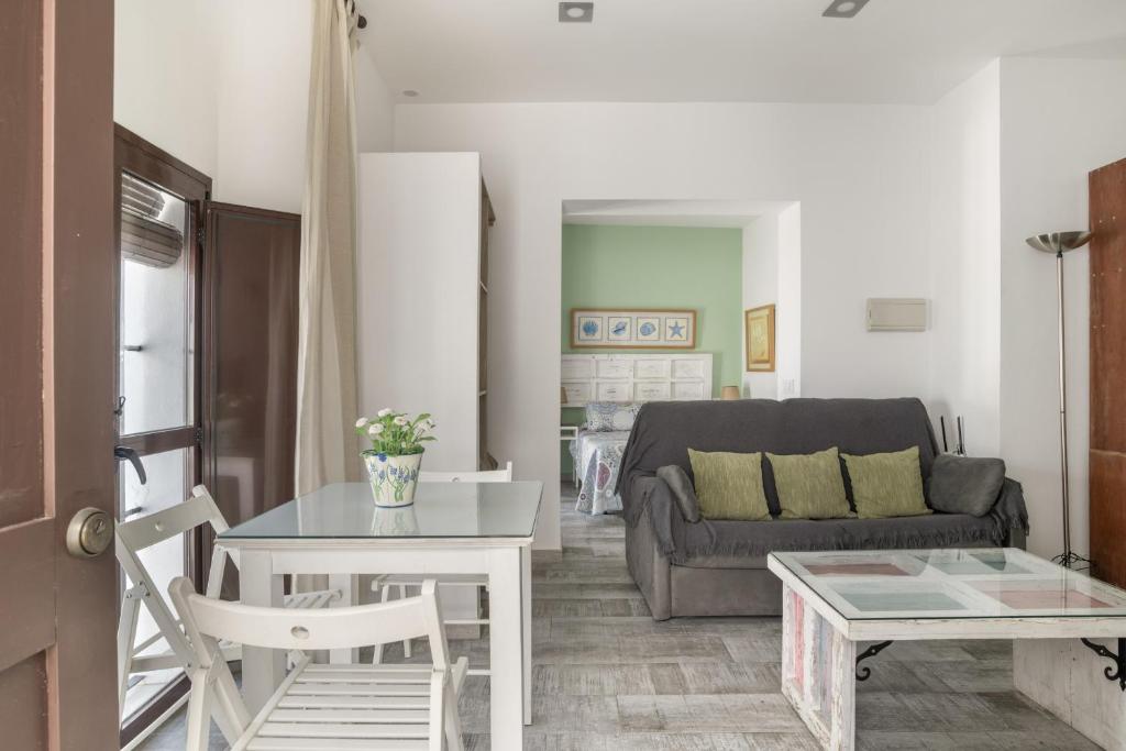a living room with a couch and a table at Girasol in Vejer de la Frontera