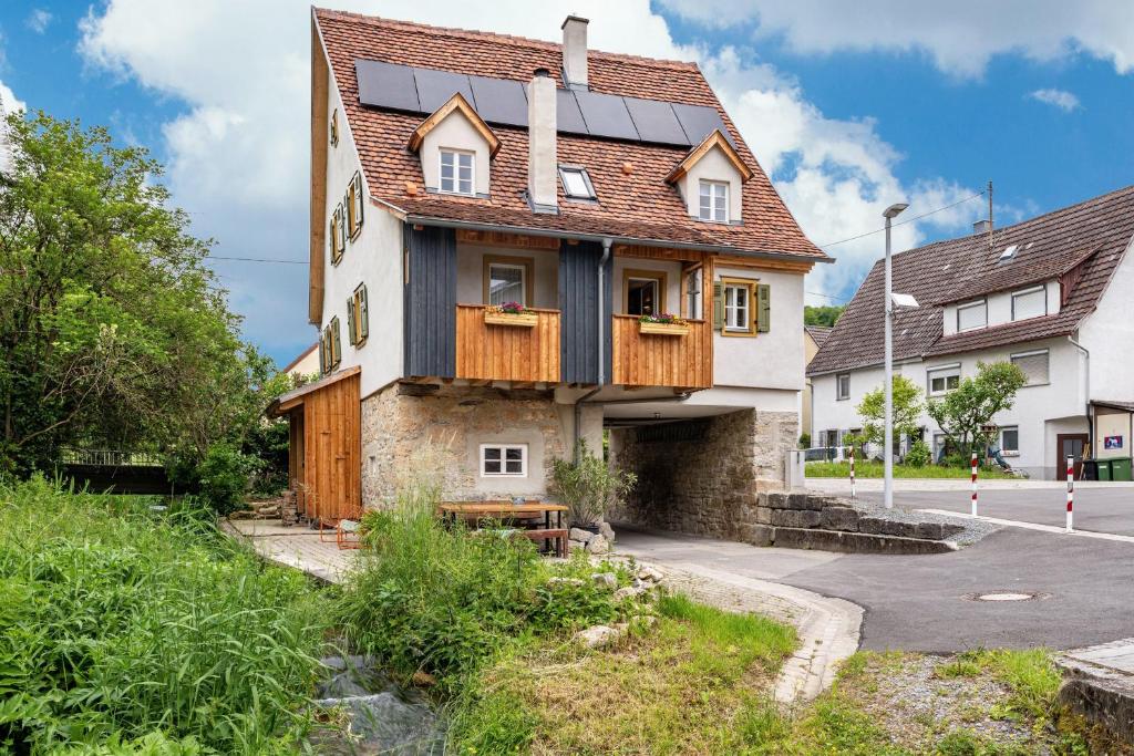 a house with solar panels on the roof at Ferienhaus Gerbertor am Goldbach in Dörzbach