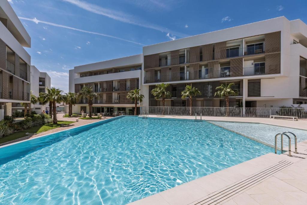 a swimming pool in front of a building at Casa Arena Rosa in Jávea