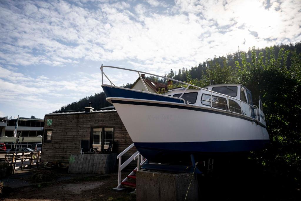 a blue and white boat parked next to a building at Das Boot Triberg in Triberg