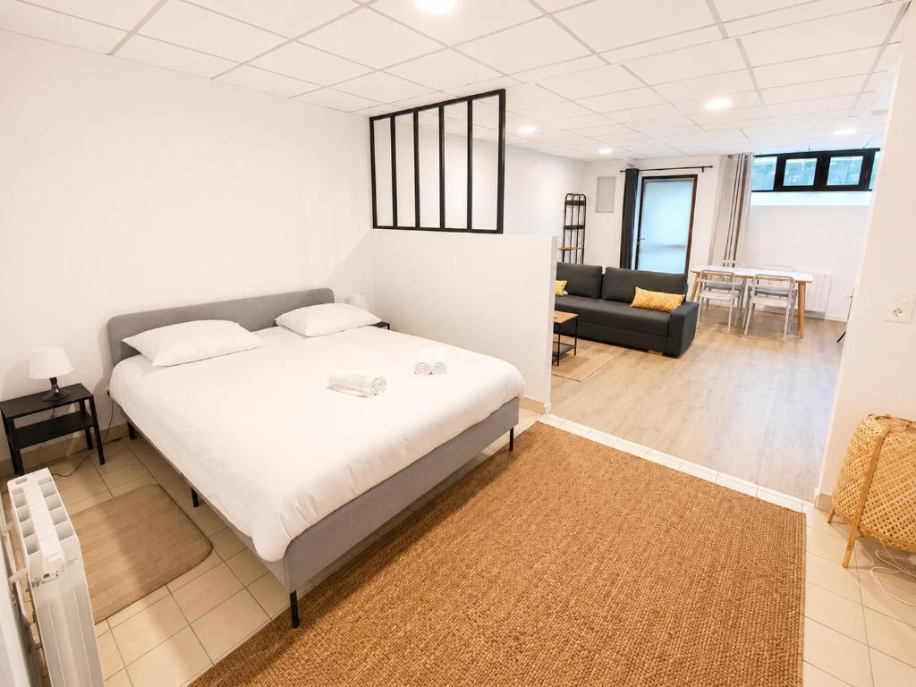 a bedroom with a bed and a living room at Studio des quais in Saint-Aignan
