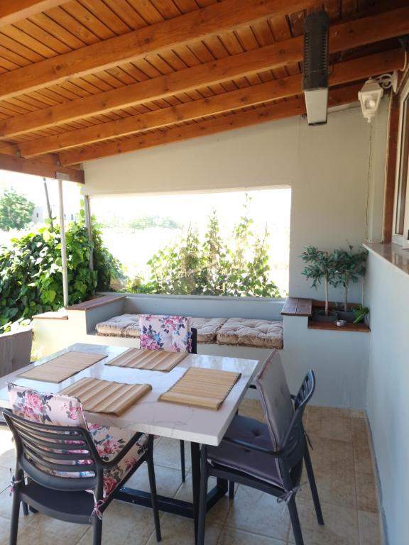 a patio with a table and chairs and a couch at komi's family house in Kómi