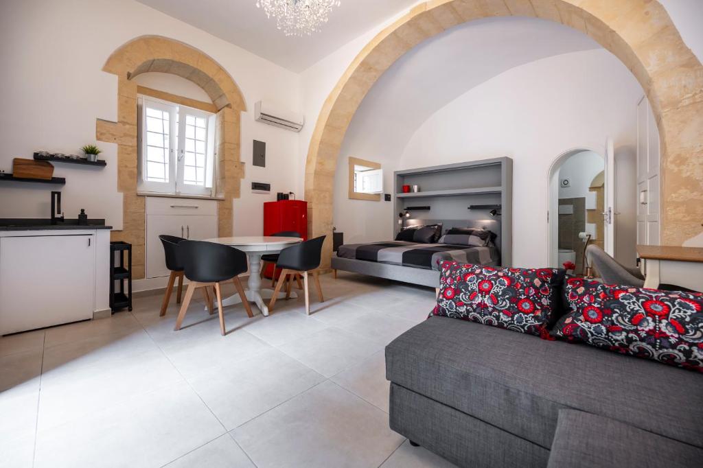 a living room with a couch and a table at Kore in Noto