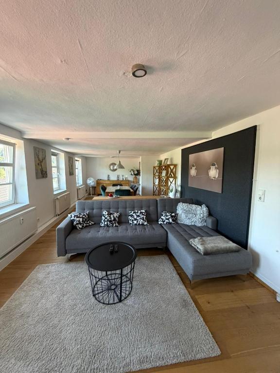 a living room with a couch and a table at Über der Brücke in Melsungen