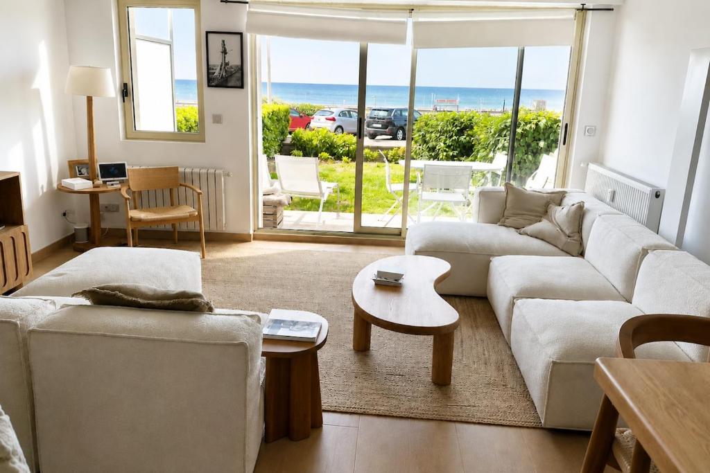 a living room with a couch and a table at Le Touquet Beach, Front de Mer & Garage in Le Touquet-Paris-Plage