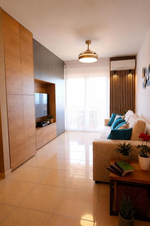 a living room with a couch and a television at Relax Mandre 200m from the beach Sea view in Mandre