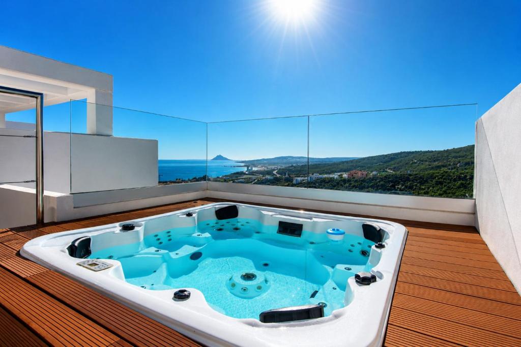 a jacuzzi tub in a bathroom with a view at Golden View 2460 in Manilva
