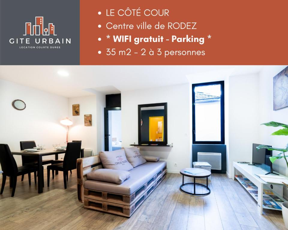 a living room with a couch and a table at LE CÔTÉ COUR in Rodez