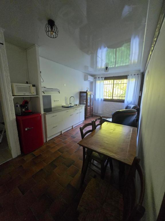 a living room with a table and a kitchen at la roussette in Prats-de-Mollo-la-Preste