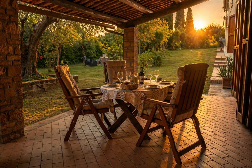 a table and chairs sitting on a patio at Casa Adele - 10 min from the sea! in Carignano