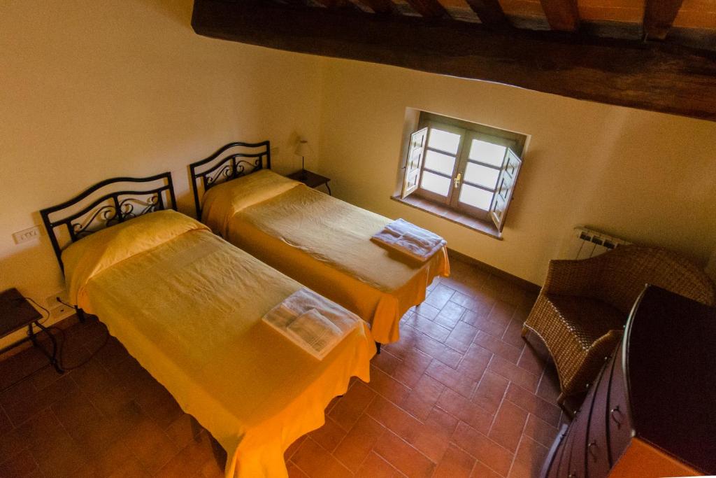 Postel nebo postele na pokoji v ubytování Frantoio di Corsanico