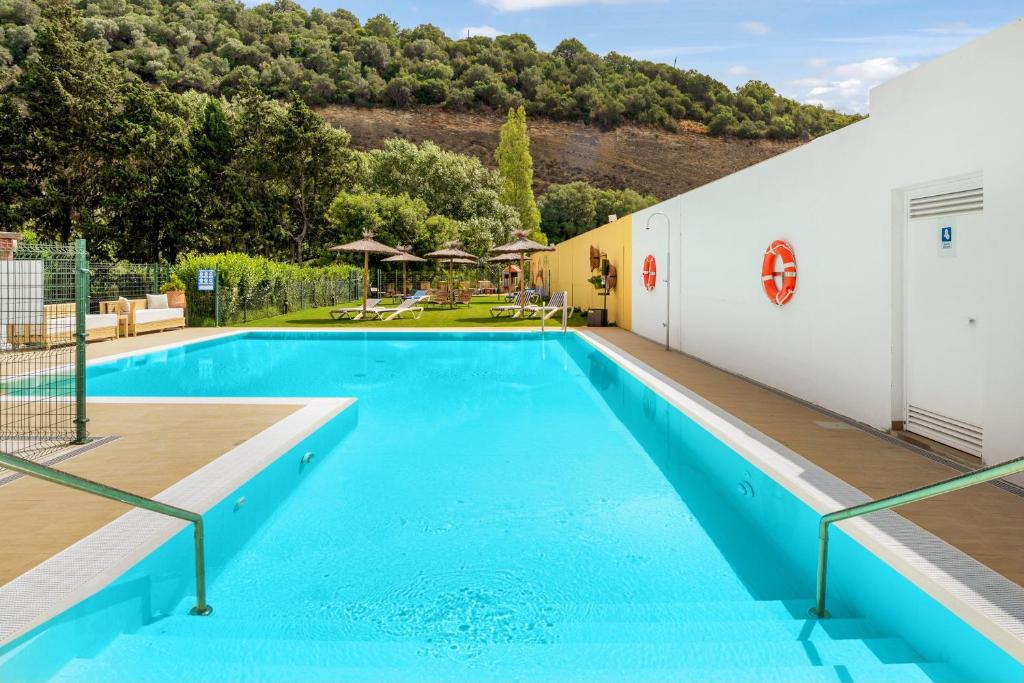 a swimming pool with blue water in a building at Casa de 10 - 2a in Vejer de la Frontera