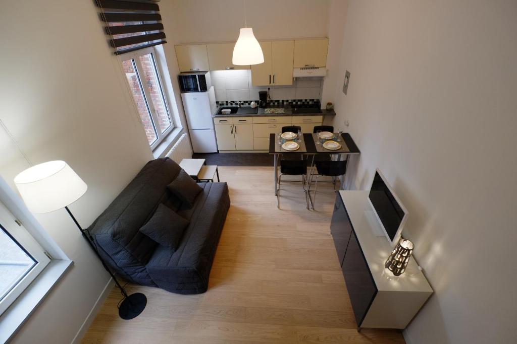 a small living room with a couch and a table at Appartement Plaisance in Lille