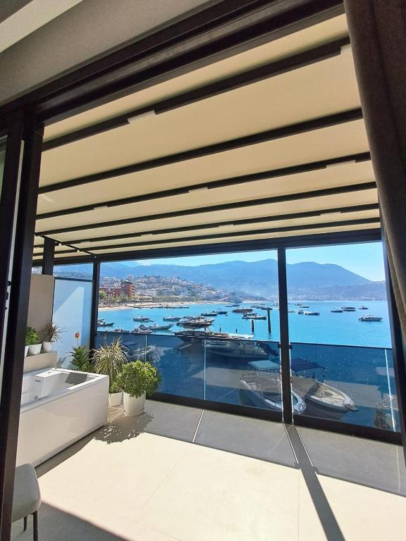 a bathroom with a large window with a view of the water at Artis Blue Relax in Himare