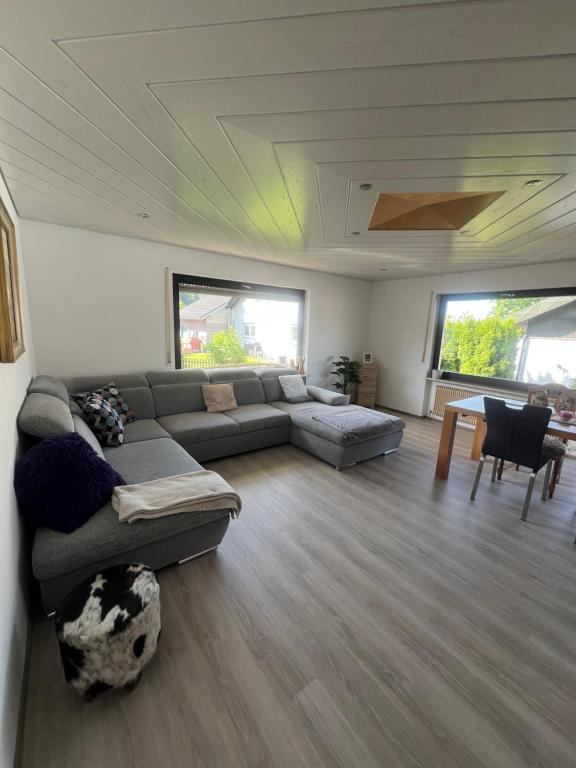 a living room with a couch and a table at Tannennest in Seewald