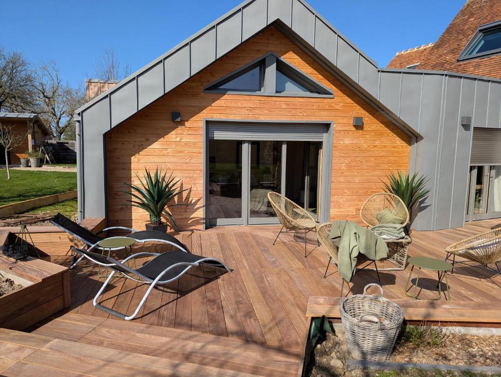 a wooden deck with chairs and a table at Apart'é in Saint-Brisson-sur-Loire