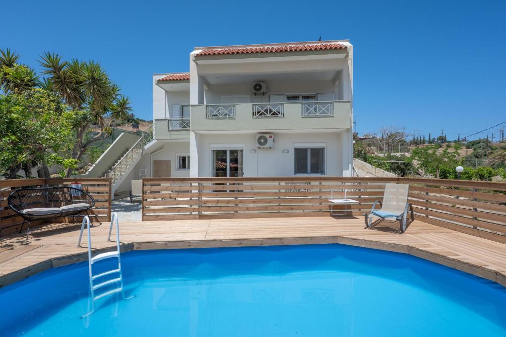 a villa with a swimming pool and a house at Villa Melenia 1 in Agia Pelagia