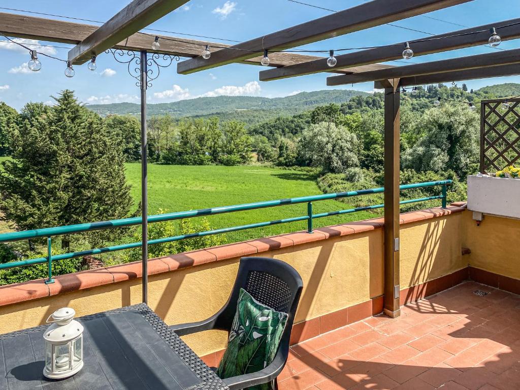 a patio with a table and chairs on a balcony at Casa Le Marie in Barberino di Mugello
