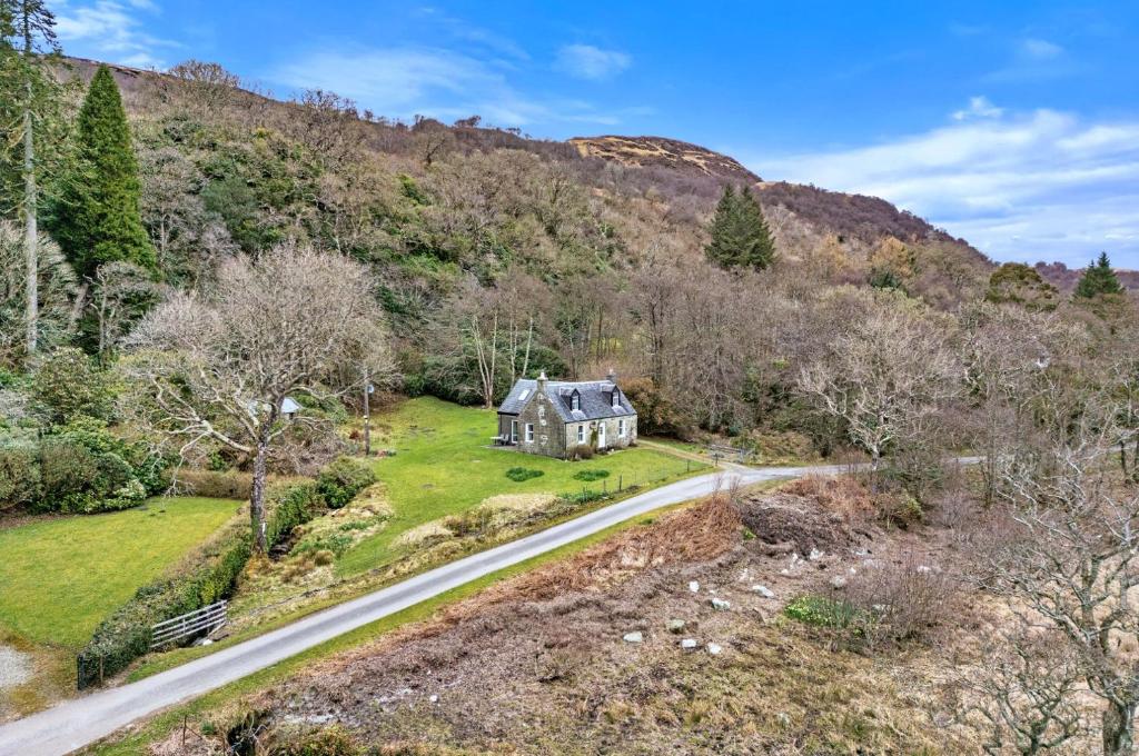 an aerial view of a house on a road at Lochead Cottage Ellary in Lochgilphead