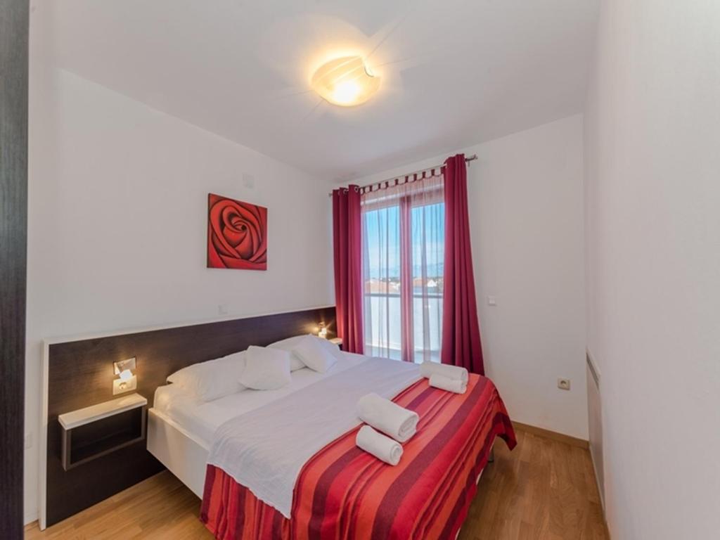 Postel nebo postele na pokoji v ubytování Apartments Dalmatia