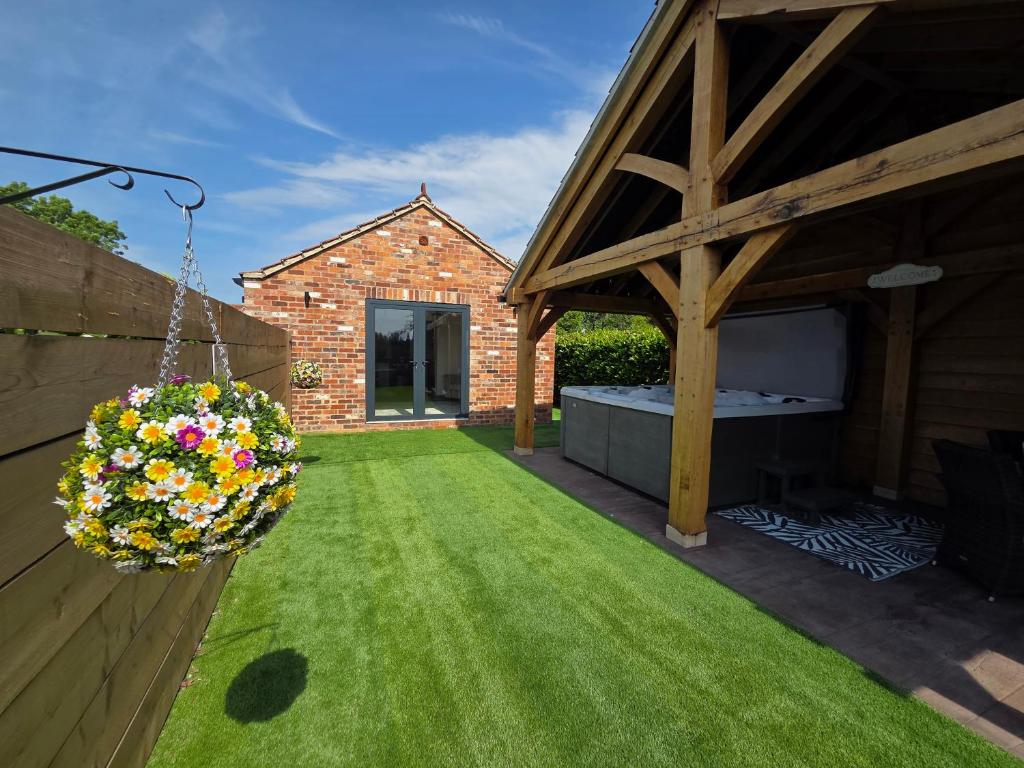 a garden with a hanging basket of flowers at Sunnie view lodge 2 bedroom in Lound