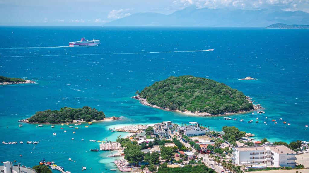 an island with a cruise ship in the water at Hotel Milo Ksamil in Ksamil