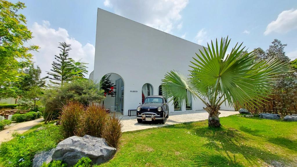 an old car parked in front of a building at LK Resort in Ban Map Khao Wan