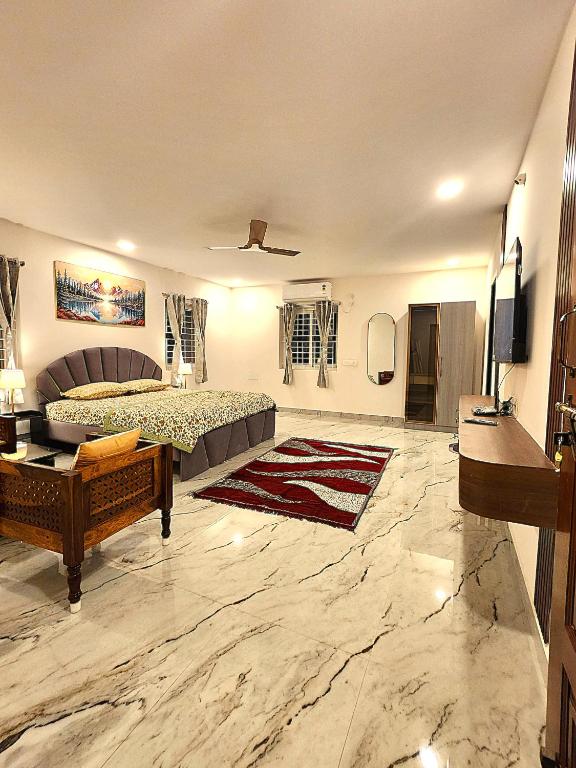a large bedroom with a bed and a tv in it at Newly Launched Servostay Luxe Botique Hotel Near Miyapur Metro in Lingampalli