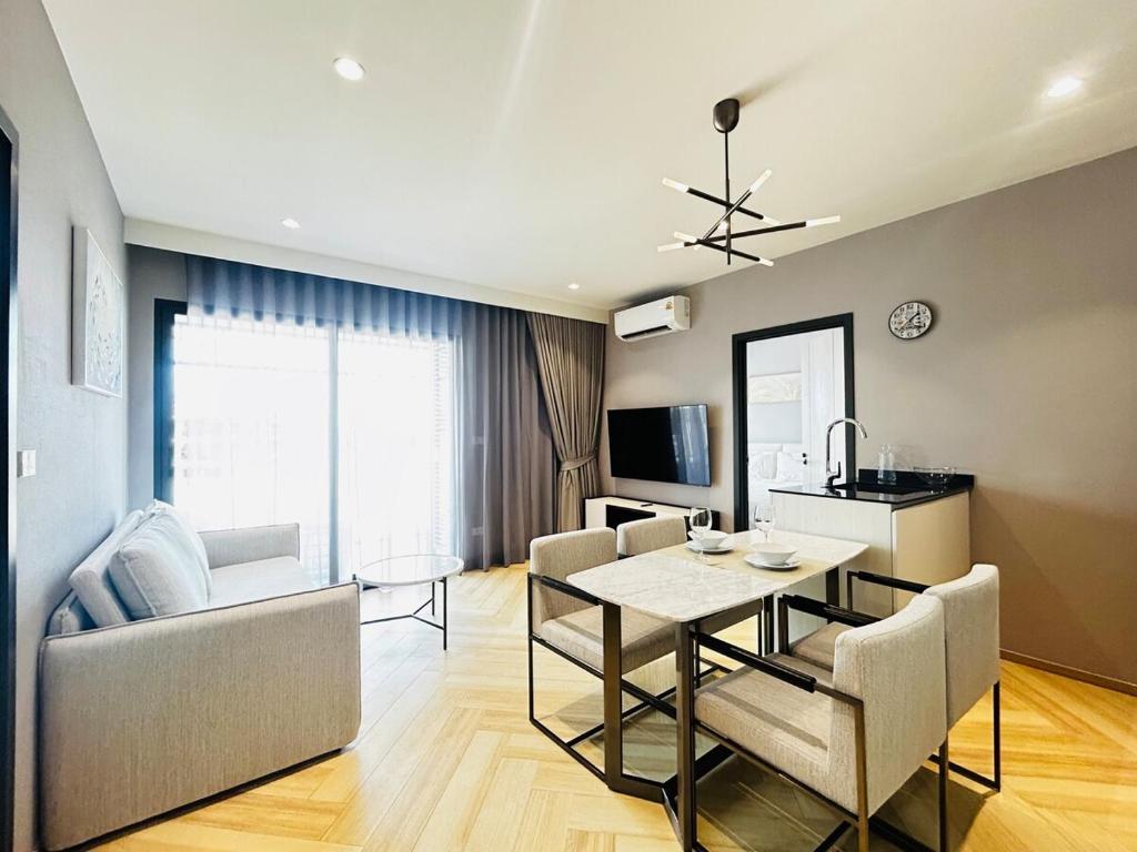 a dining room and living room with a table and chairs at Legendary 2 Bdr Comfort in Bang Tao Beach