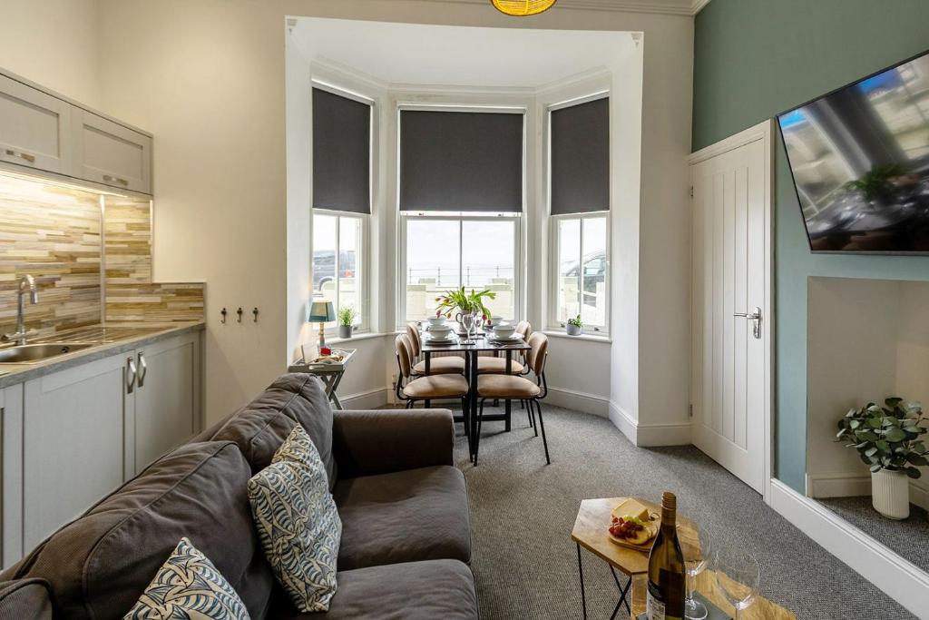 a living room with a couch and a table at Seascape - Fantastic Location with Sea Views! in Scarborough