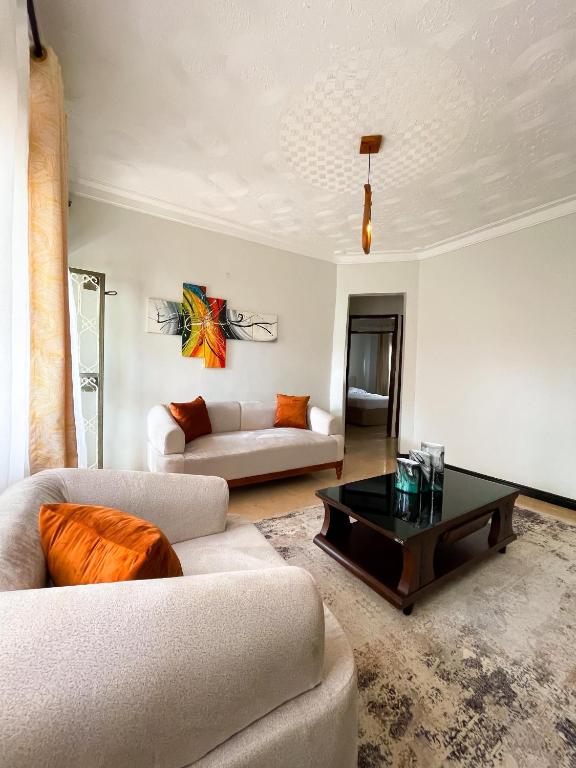 a living room with two couches and a coffee table at Happy homes stay in Namugongo
