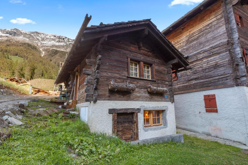 a wooden house in the mountains at Studio chaleureux au coeur d'un chalet alpin in Zinal