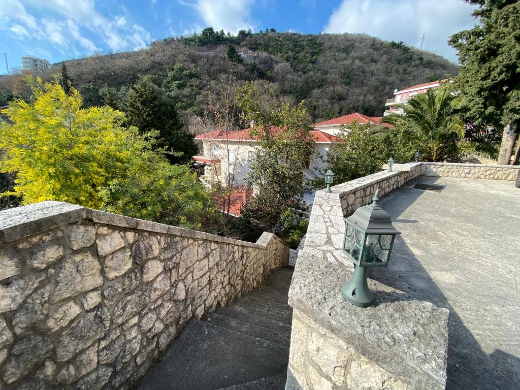 a stone retaining wall with a street light on it at Stone Villa in Bečići
